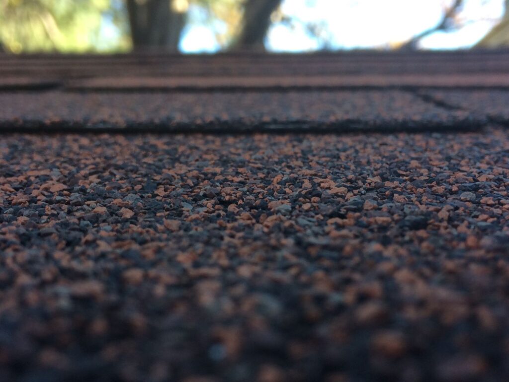 Close-up of asphalt roof shingles during a roof inspection in Mansfield